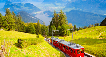 View of Tram in Front of Swiss Mountains